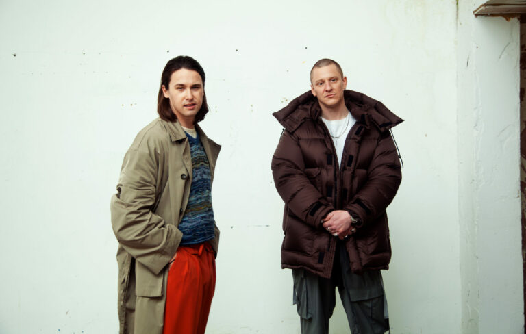 Jungle pose for a press photo next to a white wall