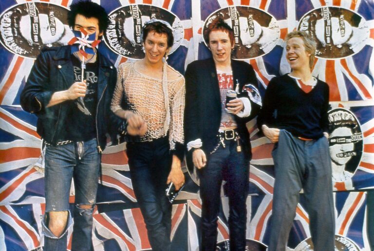 The Sex Pistols stand together against a Union Jack background