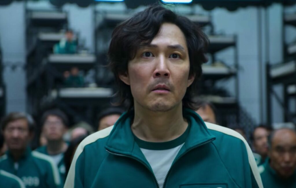 Lee Jung-Jae wears a green tracksuit and looks concerned in a headshot from 'Squid Game'