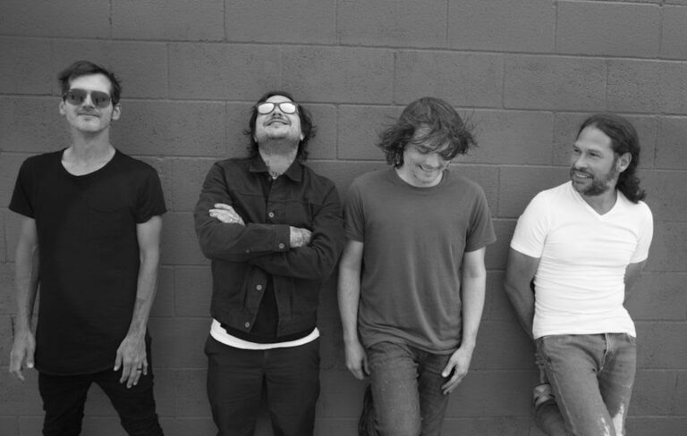 My Chemical Romance posing in black-and-white against a brick wall