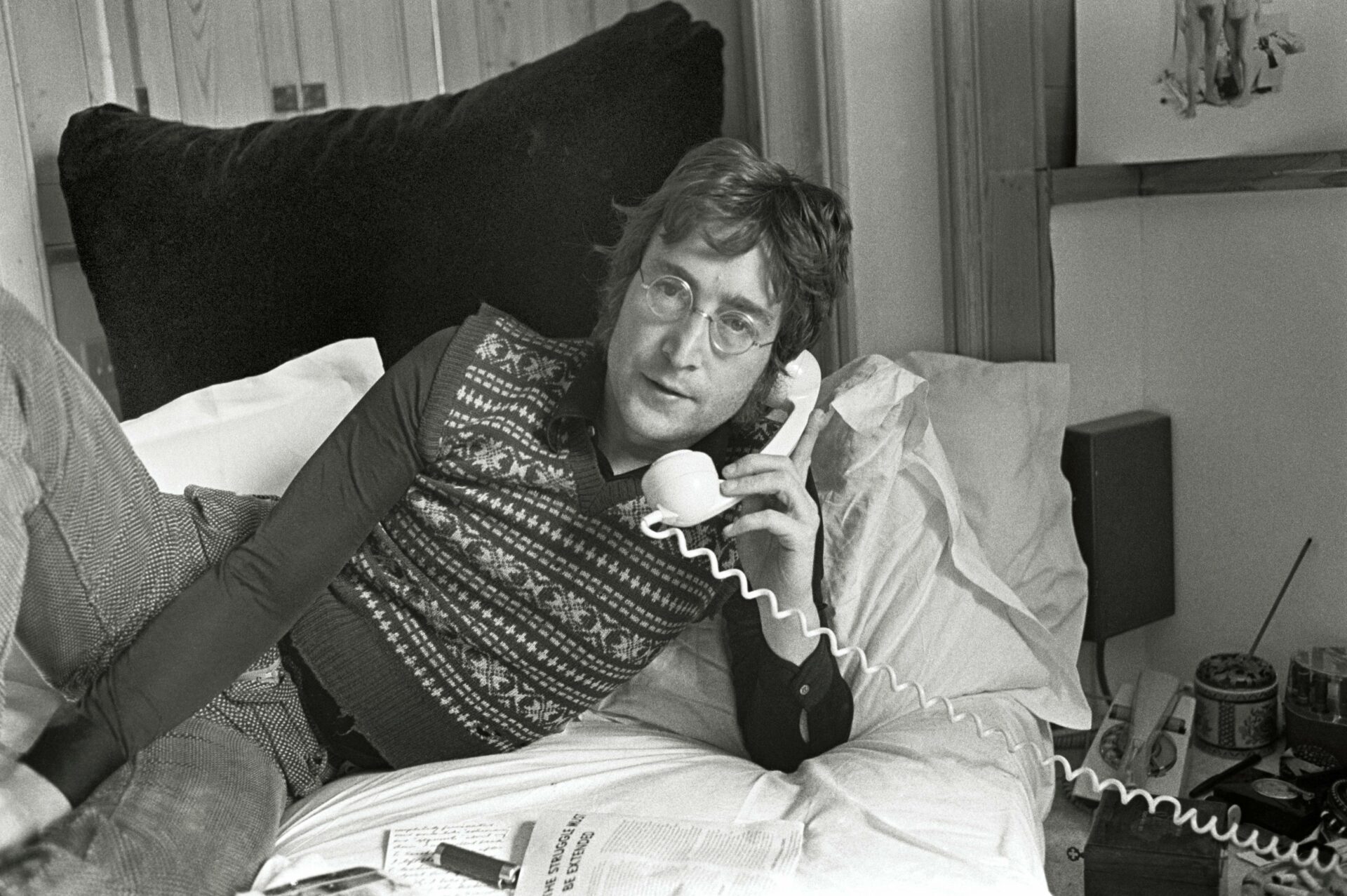 John Lennon takes a phone call (Picture: Yoko Ono/Tommy Hanley)
