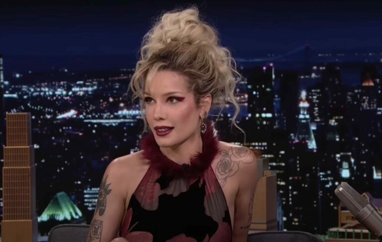 Halsey wears a red halterneck and her hair in a blonde messy bun on the Jimmy Fallon Show