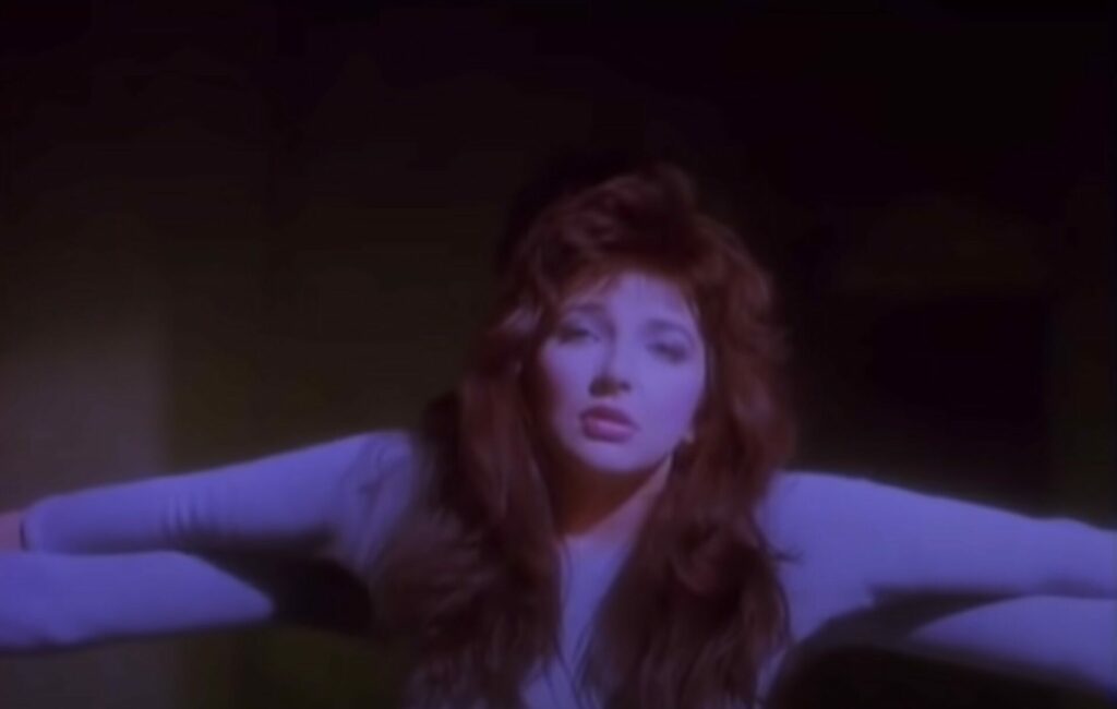 Kate Bush stretches her arms out in the music video for 'Running Up That Hill'