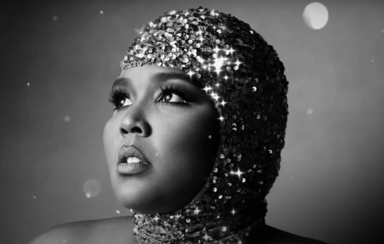 Lizzo wears a sequinned headpiece in a black and white headshot