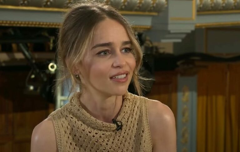 Emilia Clarke wears a beige polka dot dress in a BBC interview