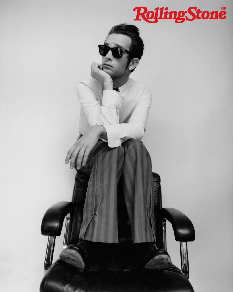 The 1975’s Matty Healy photographed for the cover of Rolling Stone UK. Matty wears vintage shirt by Prada, vintage tie, Matty’s own, trousers by Louis Vuitton, shoes by John Lobb and sunglasses by Ray-Ban