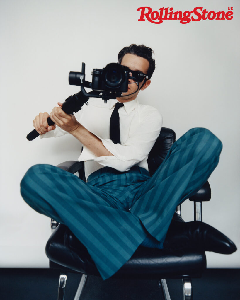 The 1975’s Matty Healy photographed for the cover of Rolling Stone UK. Matty wears vintage shirt by Prada, vintage tie, Matty’s own, trousers by Louis Vuitton, shoes by John Lobb and sunglasses by Ray-Ban
