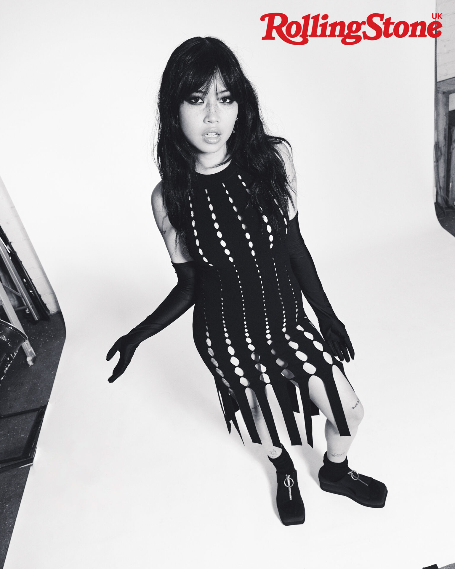 beabadoobee poses in a black corset dress in a black and white shot