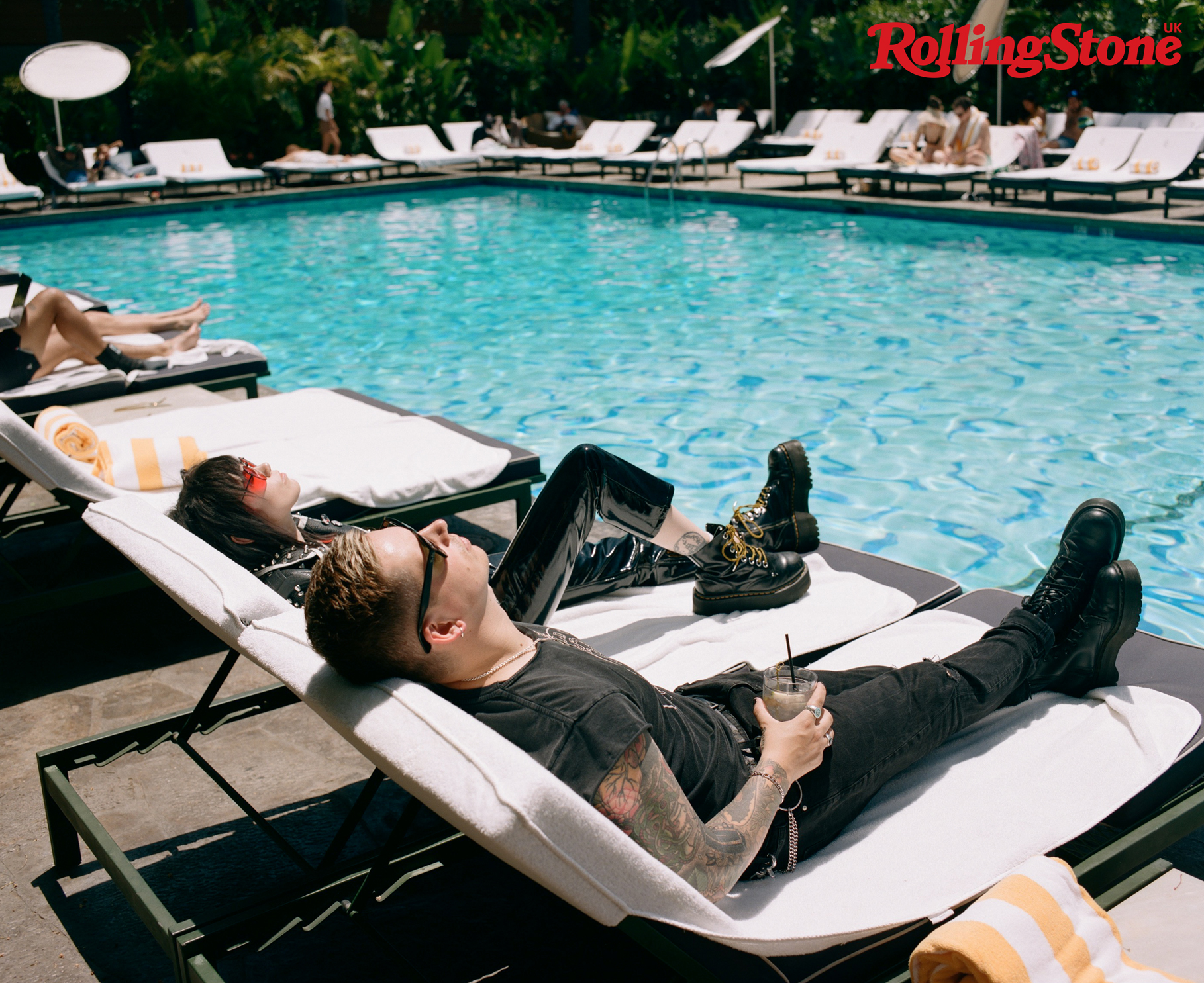 Hot Milk sunbathe on sunbeds poolside