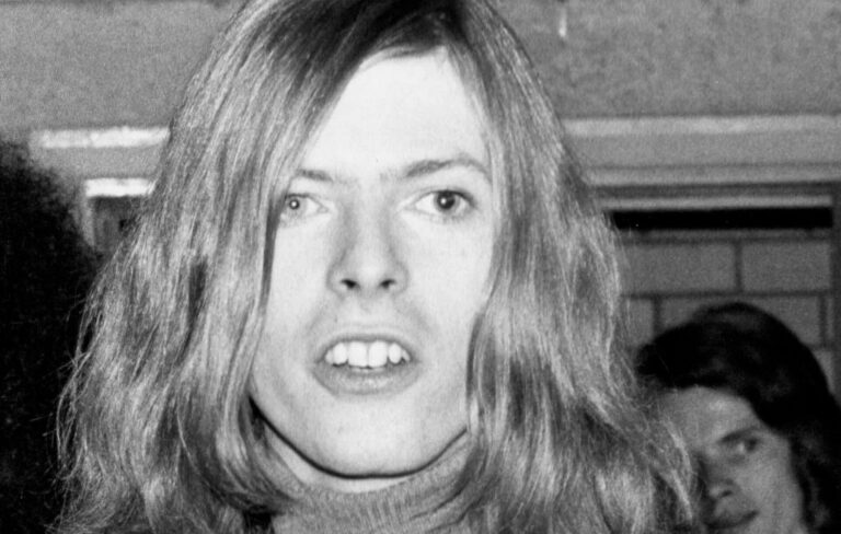 David Bowie is seen up close in a black and white photo