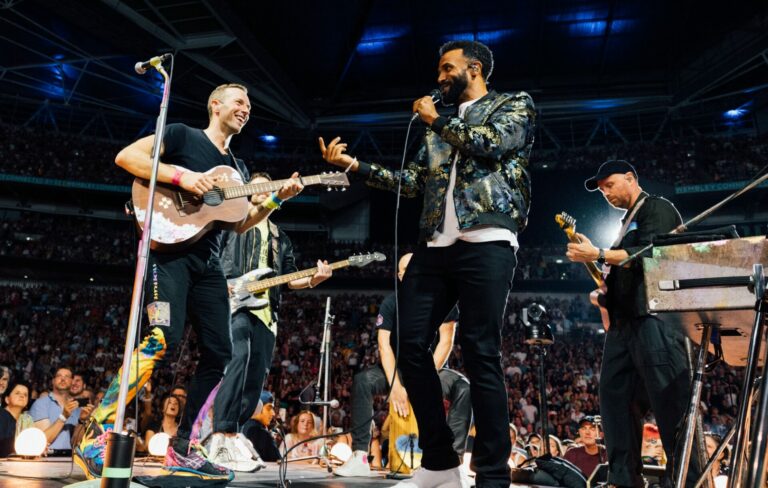 Coldplay performing live on-stage with Craig David at London's Wembley Stadium in August 2022