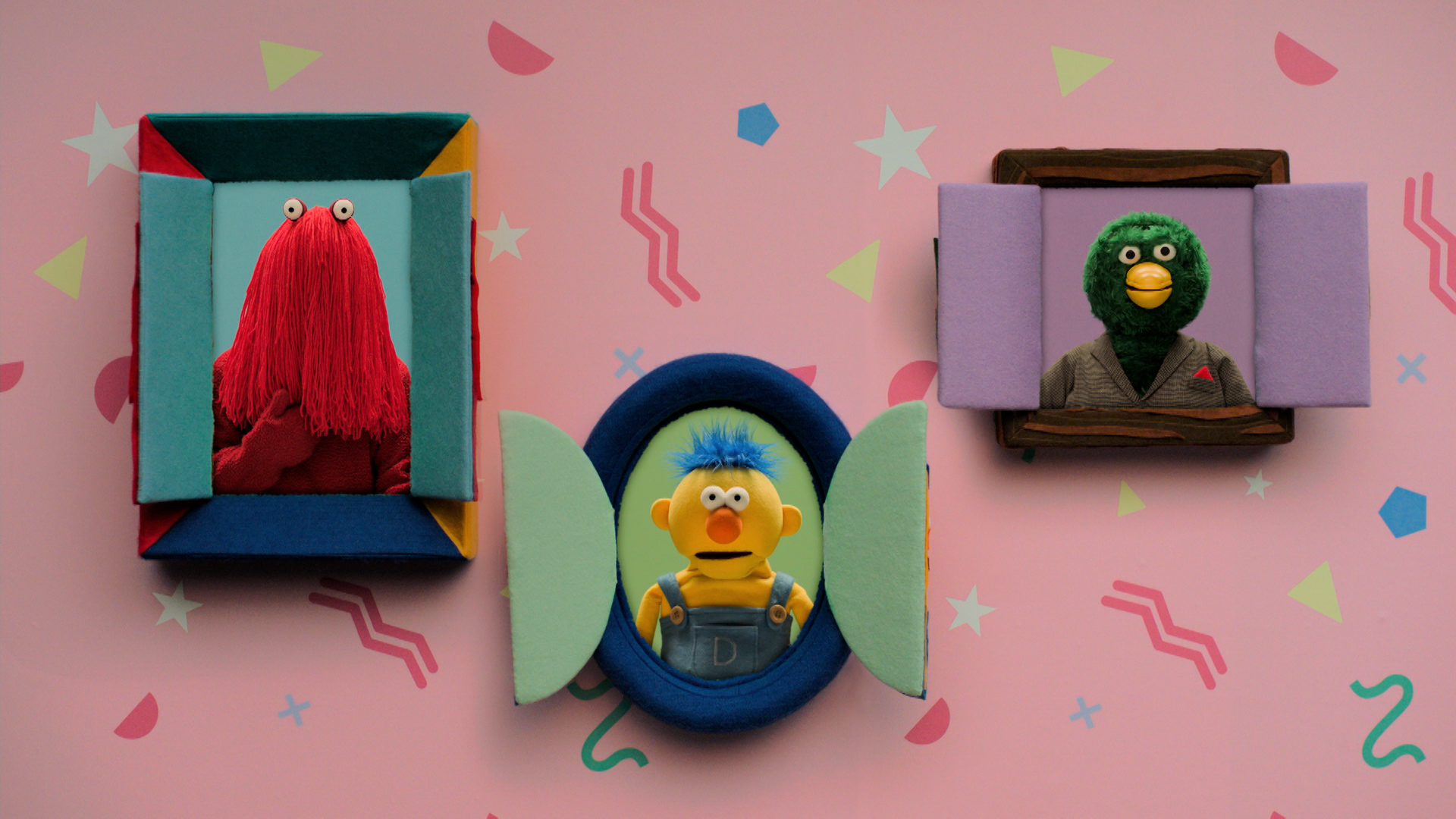 Photos of Red Guy, Yellow Guy, and Duck on the wall in the new series of ’Don’t Hug Me I’m Scared’ on Channel 4