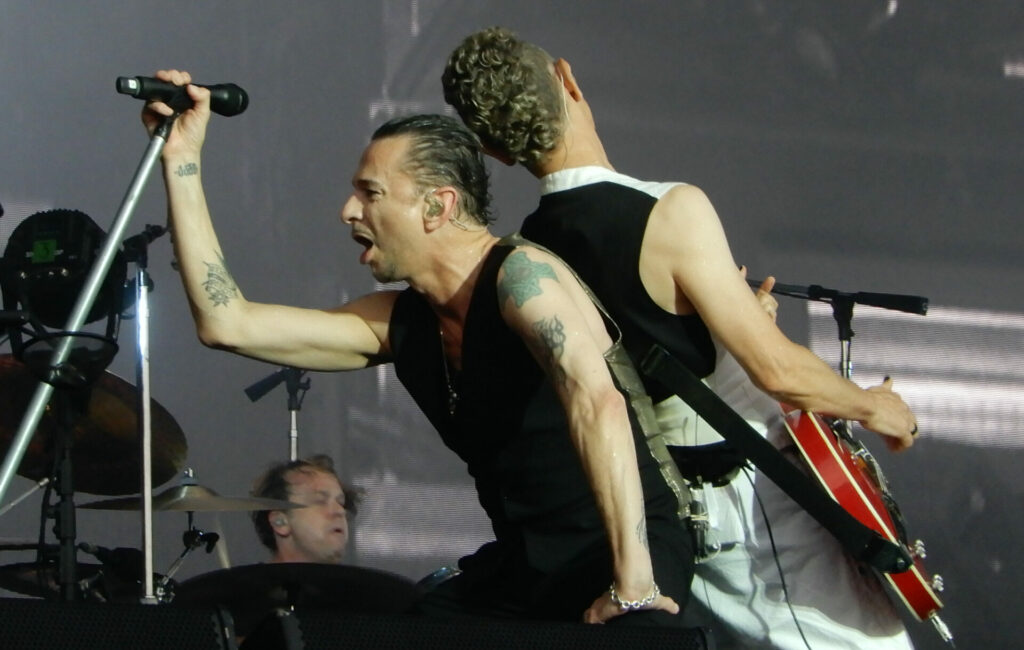 Dave Gahan (left) and Martin Gore (right) performing live on-stage with Depeche Mode in 2018
