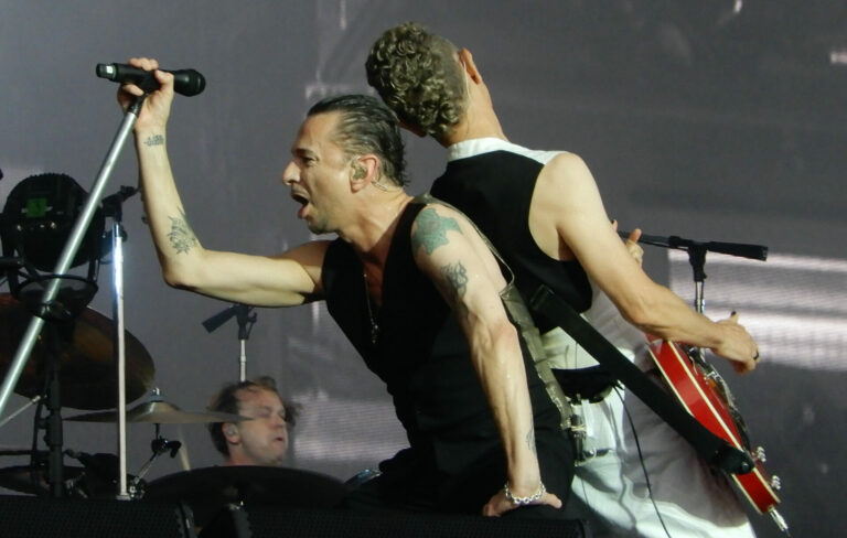 Dave Gahan (left) and Martin Gore (right) performing live on-stage with Depeche Mode in 2018