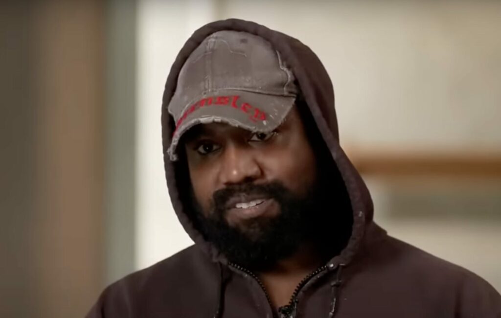 Kayne West wears a hat and hooded jumper in an interview with ABC news