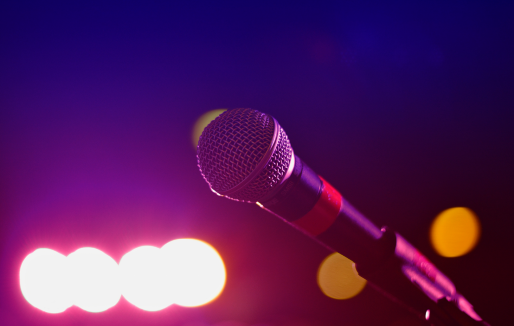 A microphone against a blue/purple background