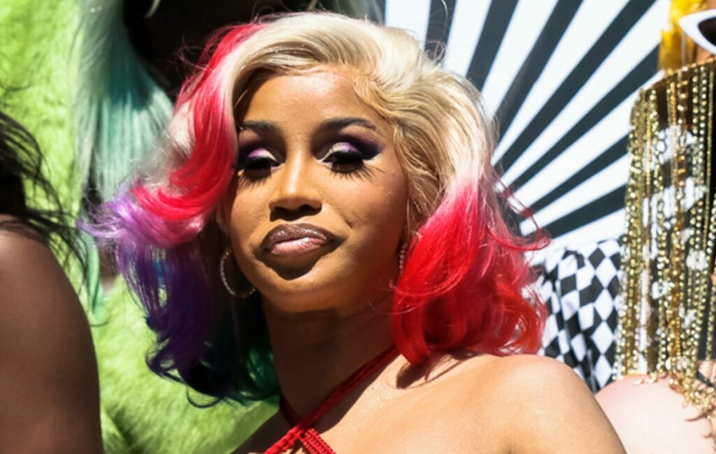 Cardi B poses in a mutli-coloured jumpsuit