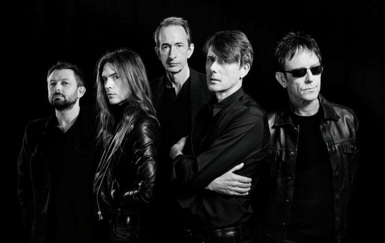 Suede pose in a black and white press photo in 2022