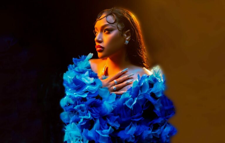 Stefflon Don picured in a blue feathered dress