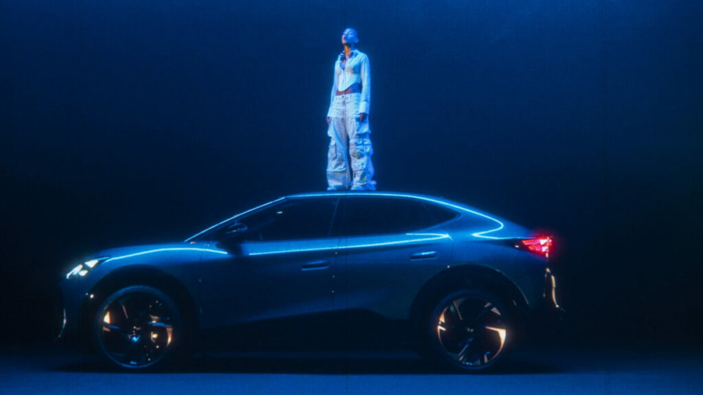 A hologram of Willow Smith stands atop a CUPRA car