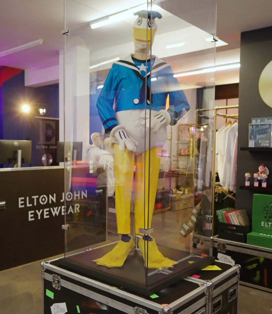 A duck suit sits inside a glass display cabinet