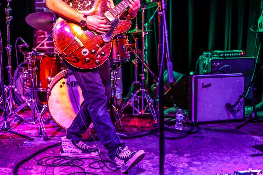 Close up of a person strumming a guitar