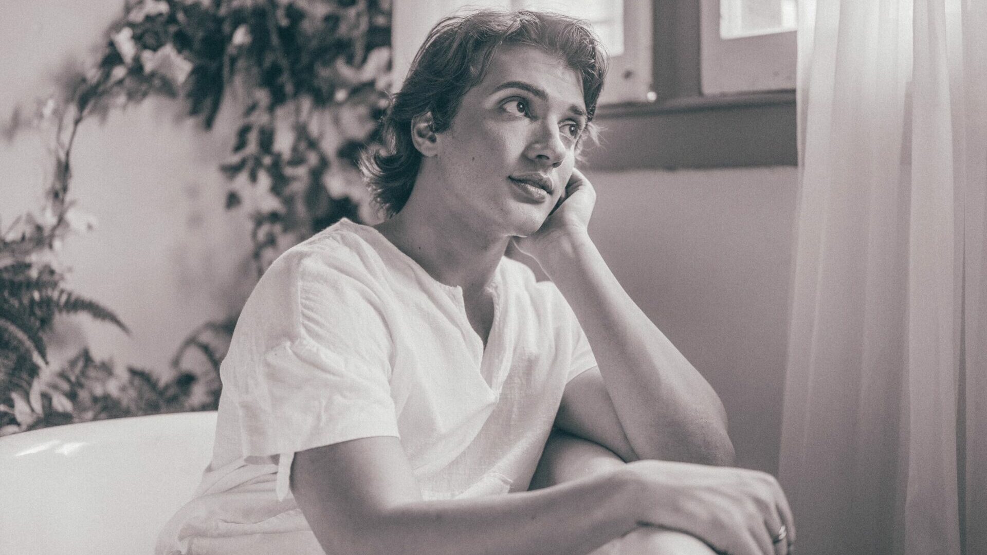 Sepia image of a man smiling into the distance