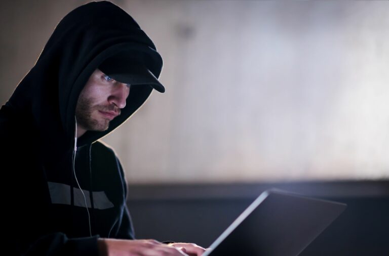 Stock image of a hacker using a laptop