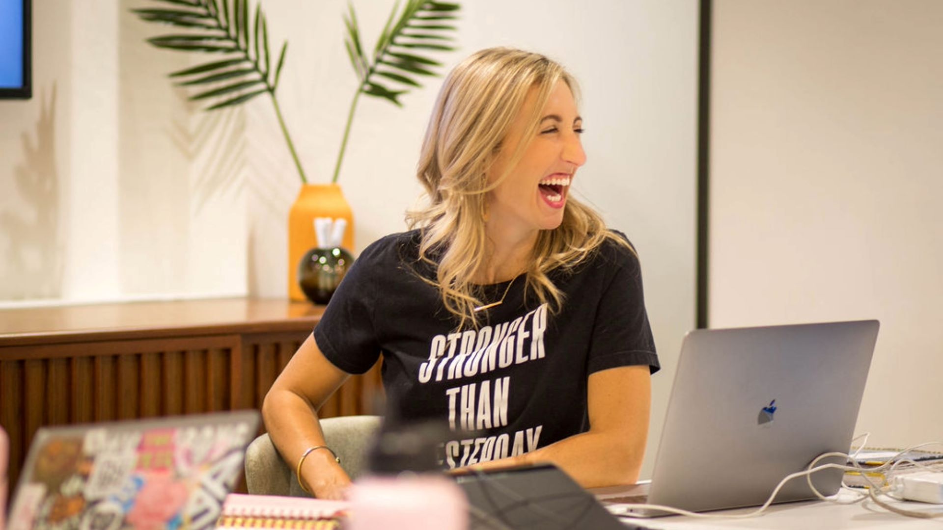 A smiling woman sitting at a desk