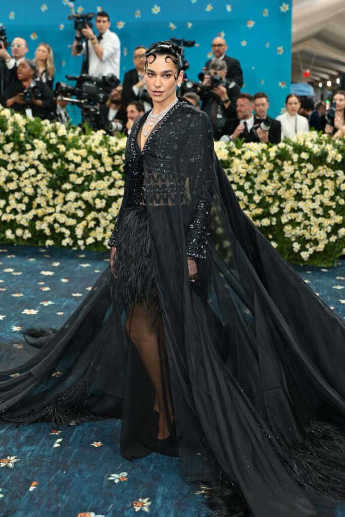Dua Lipa wears Chanel black crystal gown with feather details
