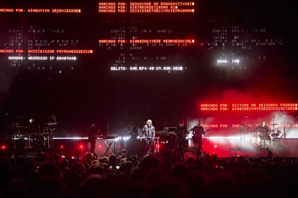 Massive Attack performing on a red-lit stage at Mallorca Live Festival 2025.