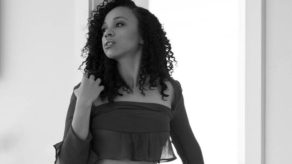 Black and white image of a woman with dark hair looking away from the camera