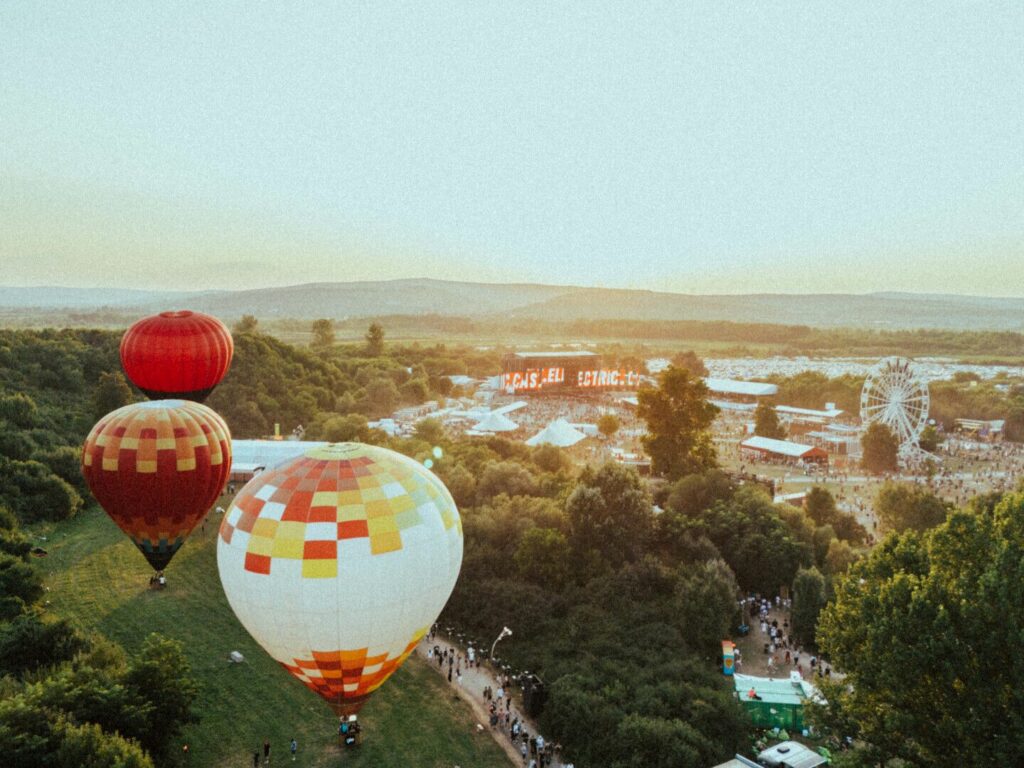 Hot air balloons flying over a festival