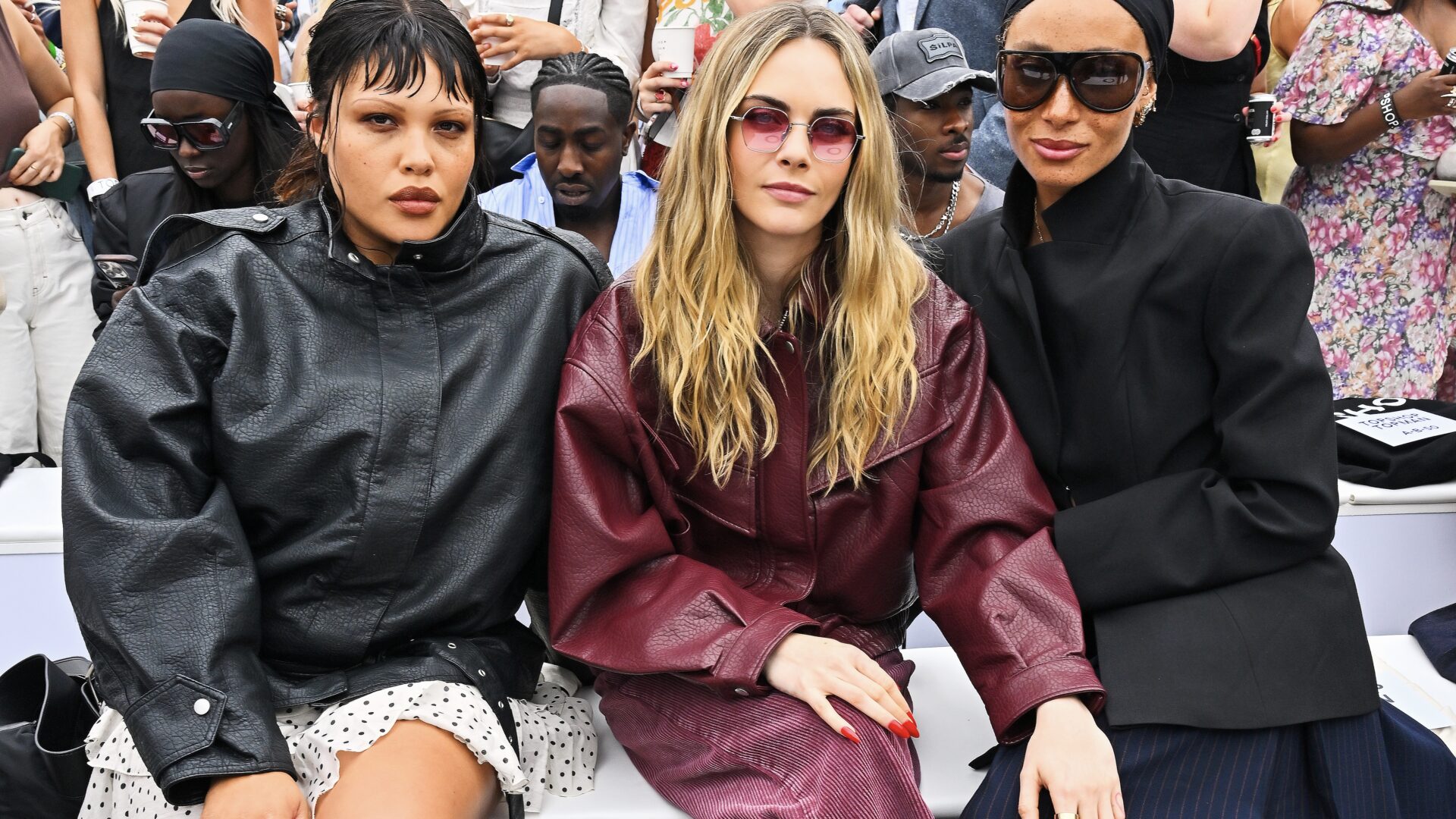 Models Alva Claire, Cara Delevingne and Adwoa-Aboah sitting front row at the Top Shop Autumn/Winter 2025 fashion show held at Trafalgar Square in London.