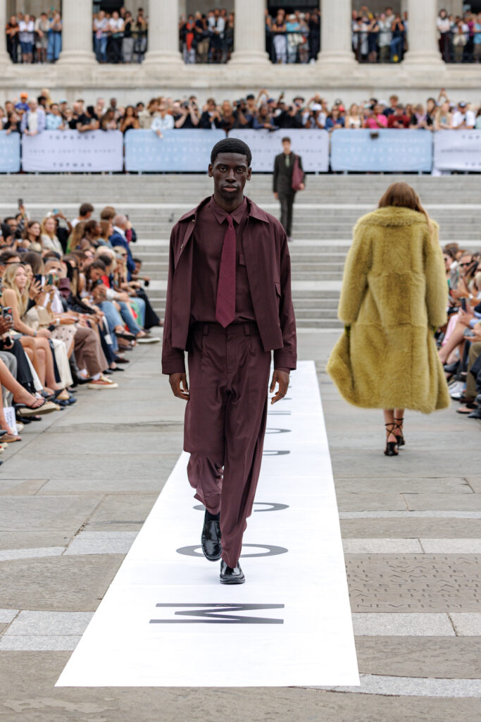 A model wearing purple tonal tailoring walks the Topman autumn/winter 2025 show in Trafalgar Square.