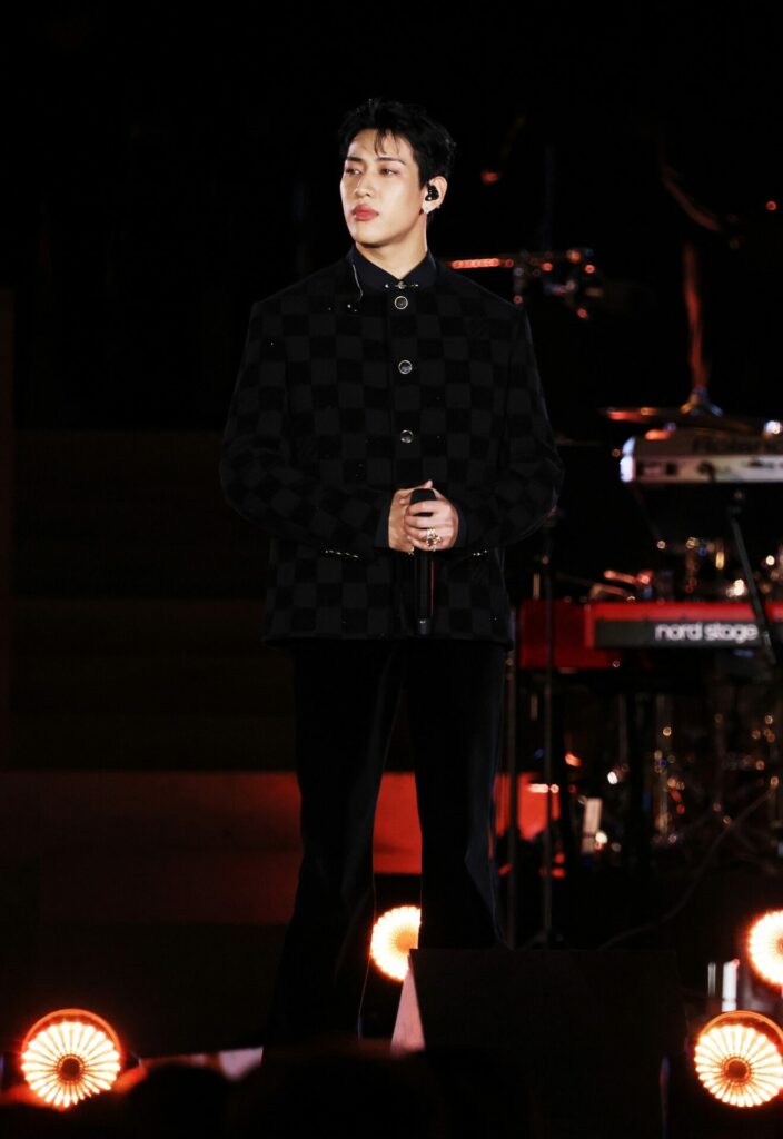 Musician BamBam wears Louis Vuitton menswear at the Grace for the world concert