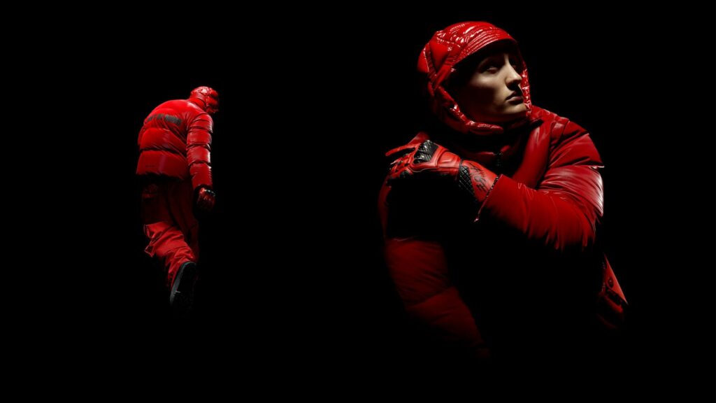 A model wears a vintage ski-inspired suit from the A$AP Rocky and Moncler Genius collection in bright red.