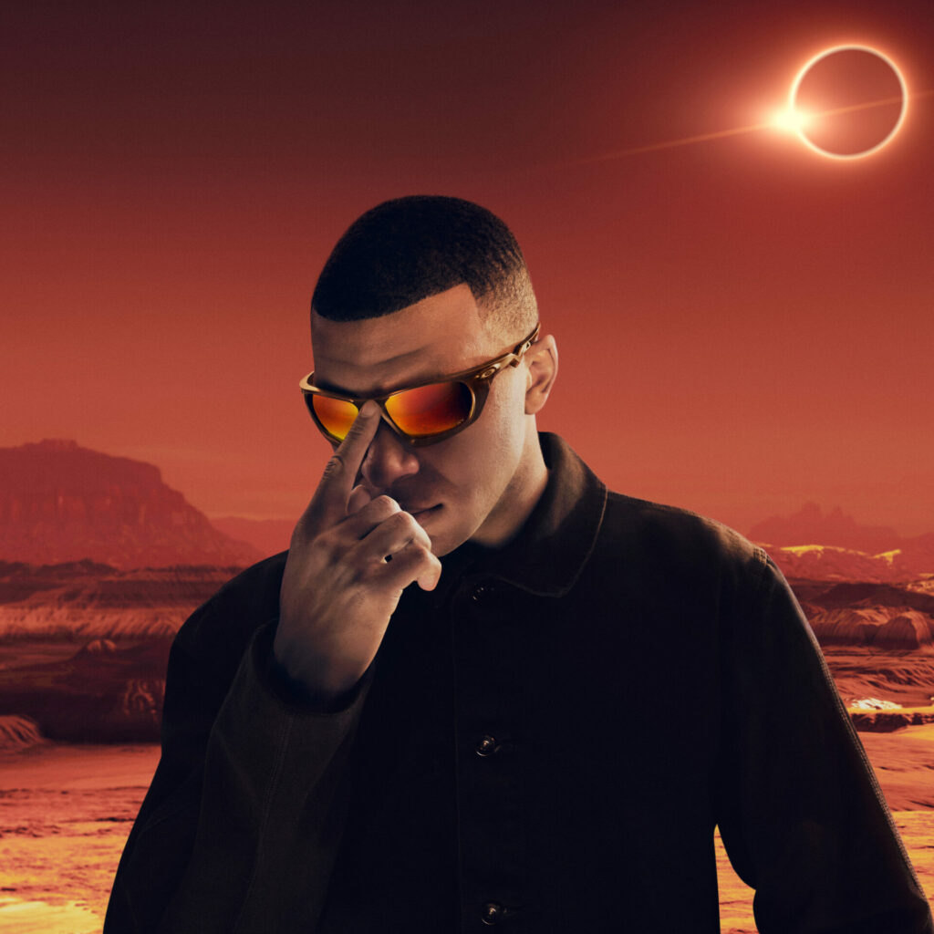 A lifestyle shot of French footballer Kylian Mbappé wearing his collaboration with Oakley.