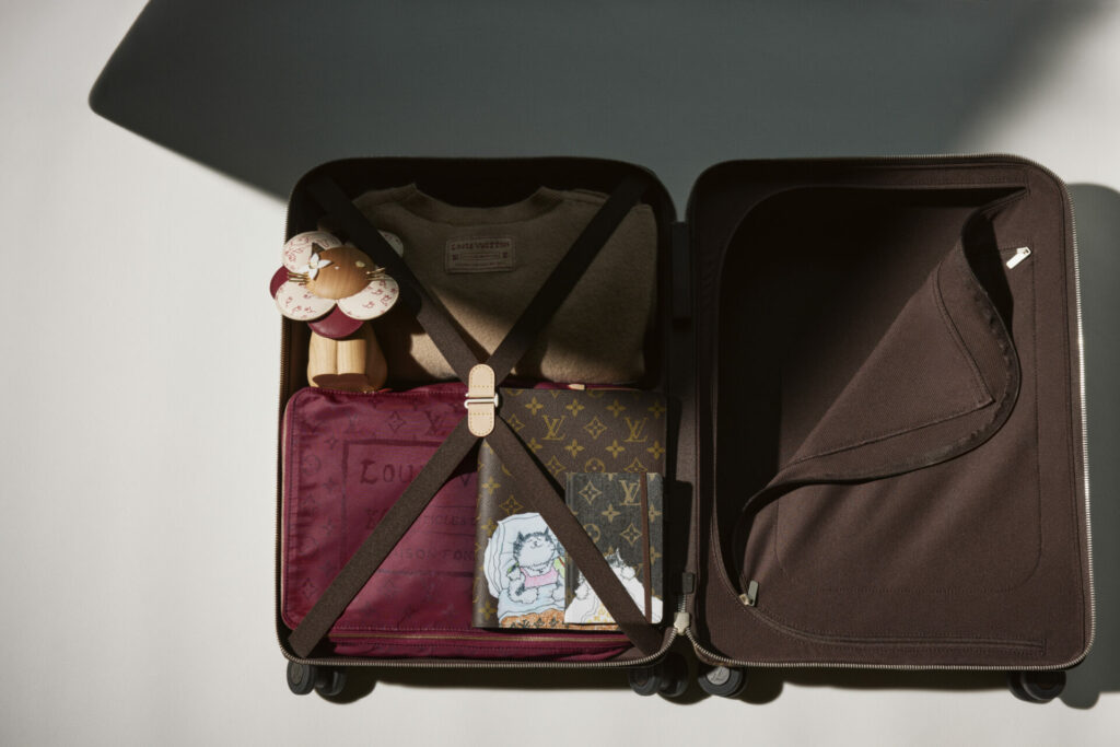 A close-up of an open Louis Vuitton suitcase from the Louis Vuitton Travels with Grace Coddington collection