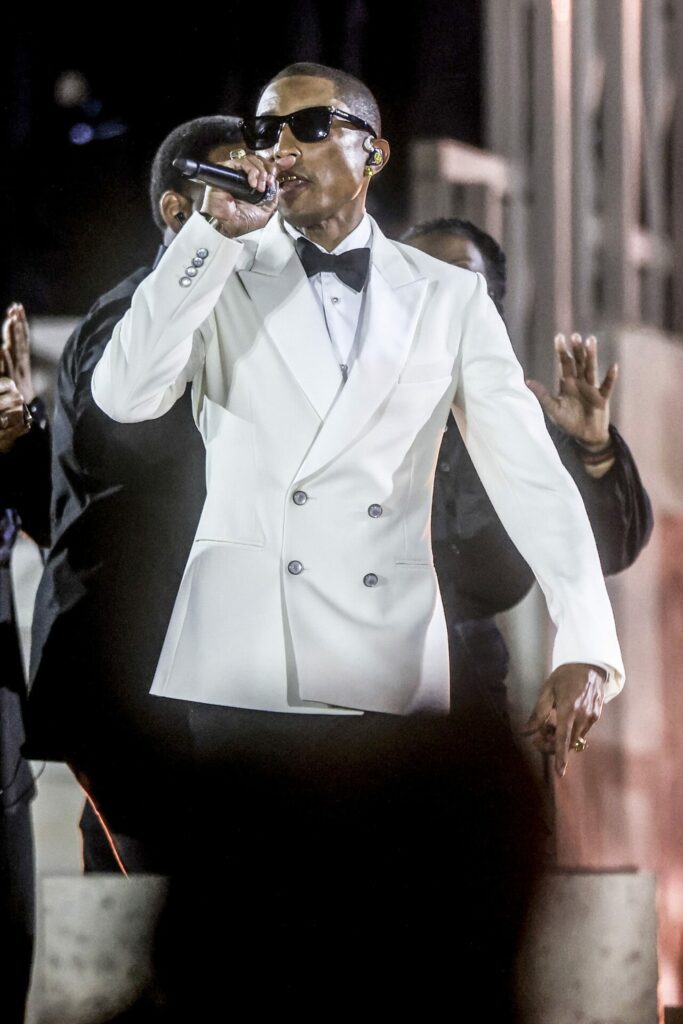 Pharrell Williams wearing custom Louis Vuitton menswear while performing at the Grace for the World concert 