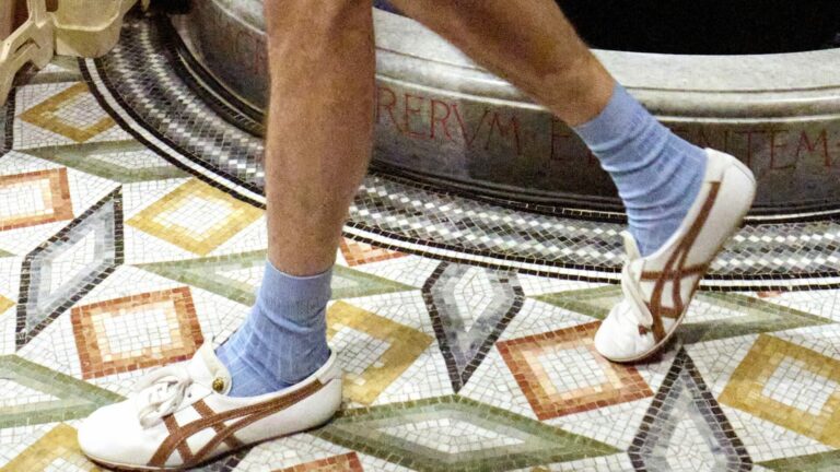 A close-up shot of the Versace x Onitsuka Tiger trainer at the Versace Spring/Summer 2026 runway show in Milan