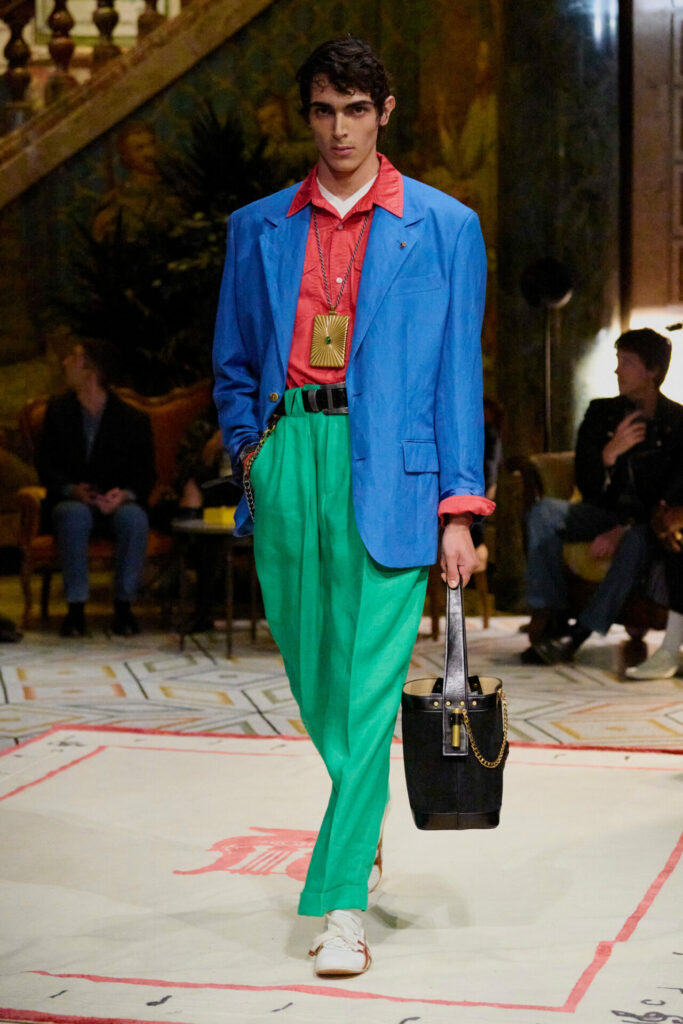 A model walks the Versace Spring/Summer 2026 runway show in Milan wearing the Onitsuka Tiger collaboration trainers.