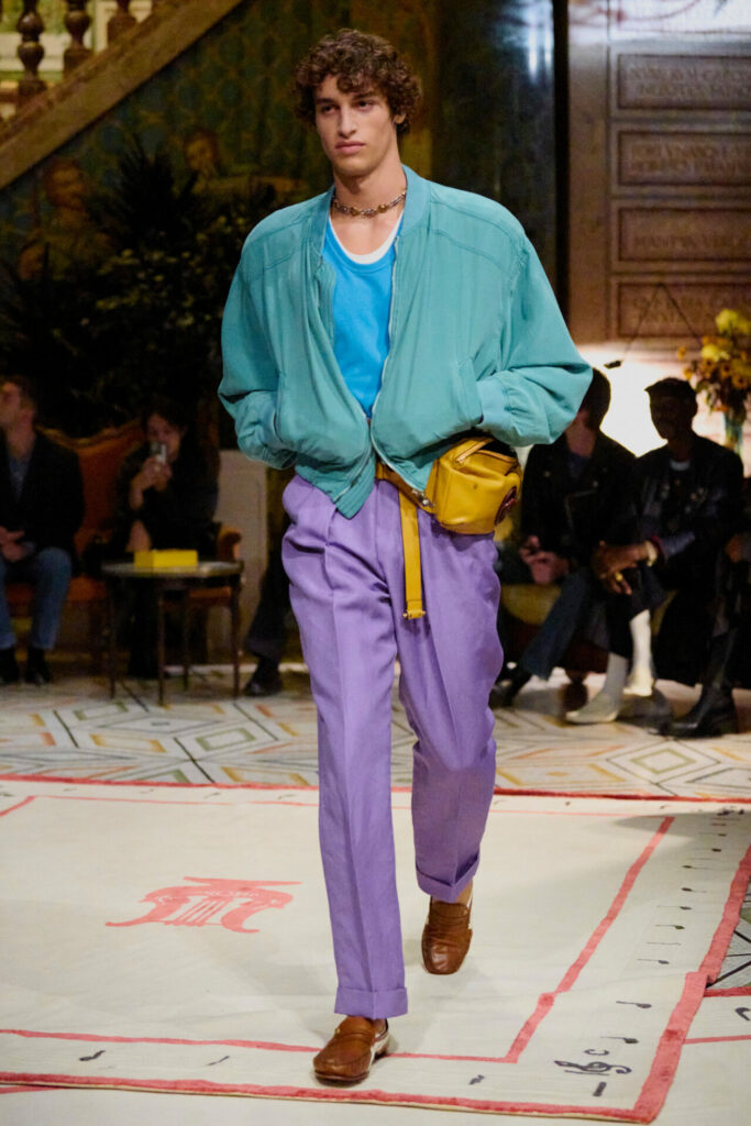 A model walks the Versace Spring/Summer 2026 runway show in Milan wearing the Onitsuka Tiger collaboration trainers.