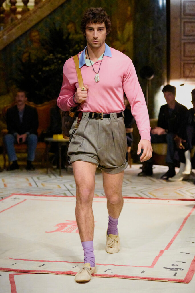 A model walks the Versace Spring/Summer 2026 runway show in Milan wearing the Onitsuka Tiger collaboration trainers.