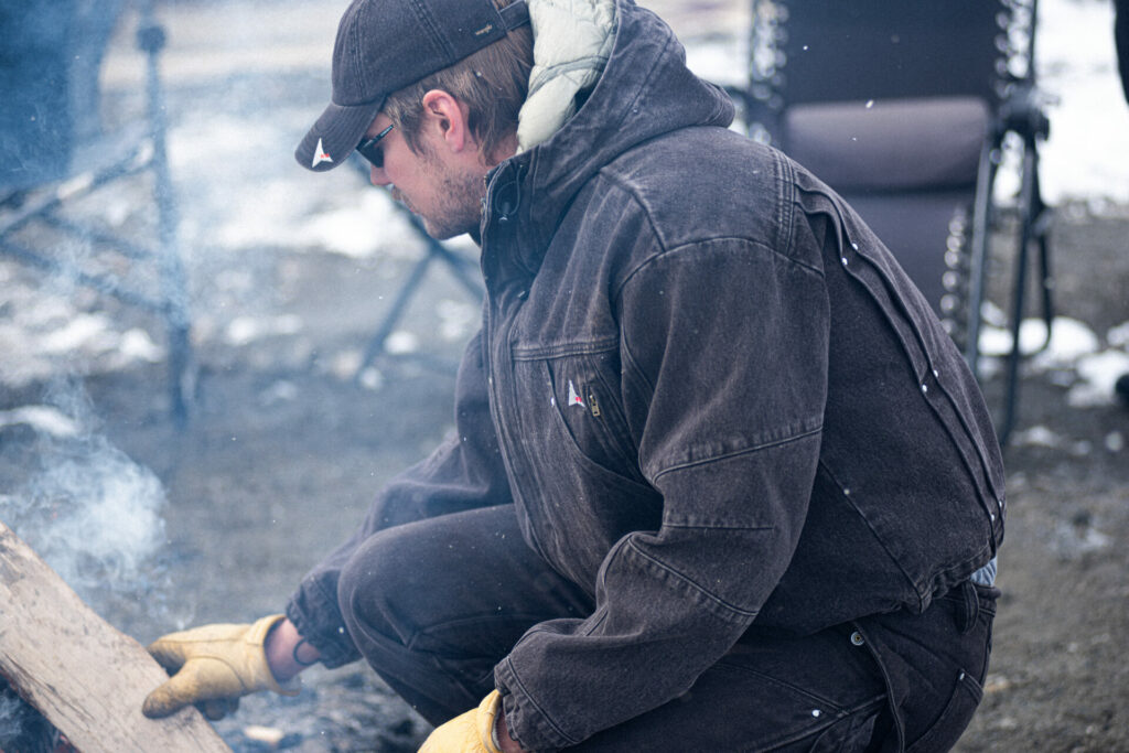 A lifestyle shot of a man wearing the Wrangler x ROA collaboration denim jacket and cap.