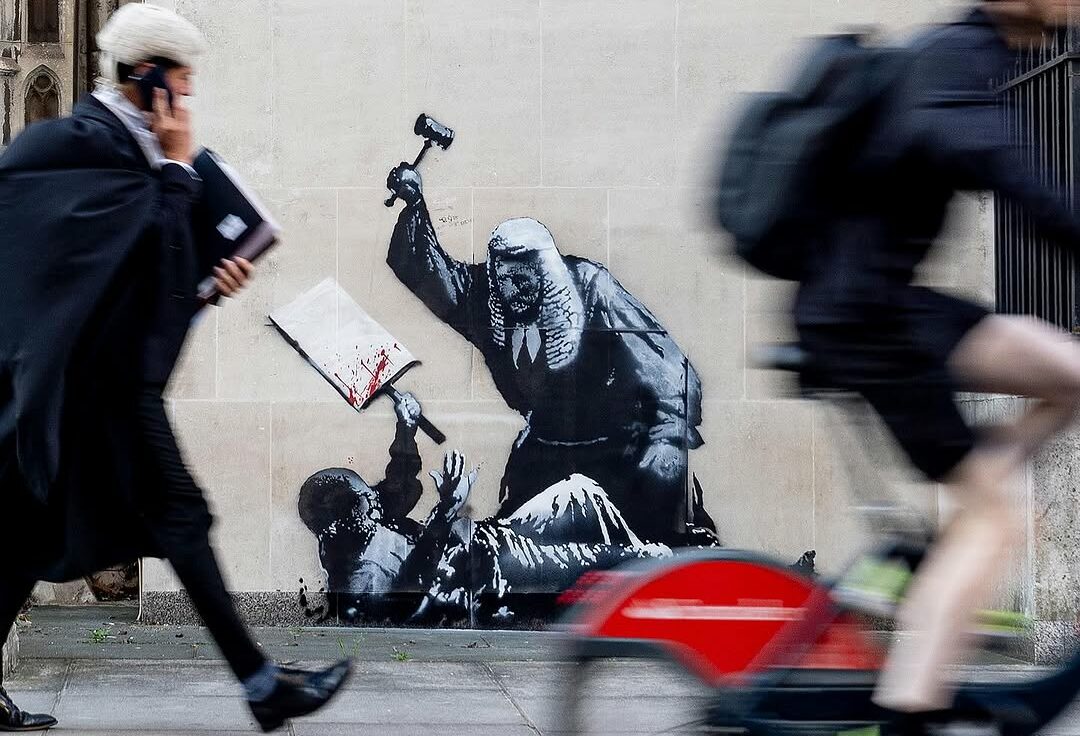A new Banksy depicting a judge attacking a protester outside the high court in London