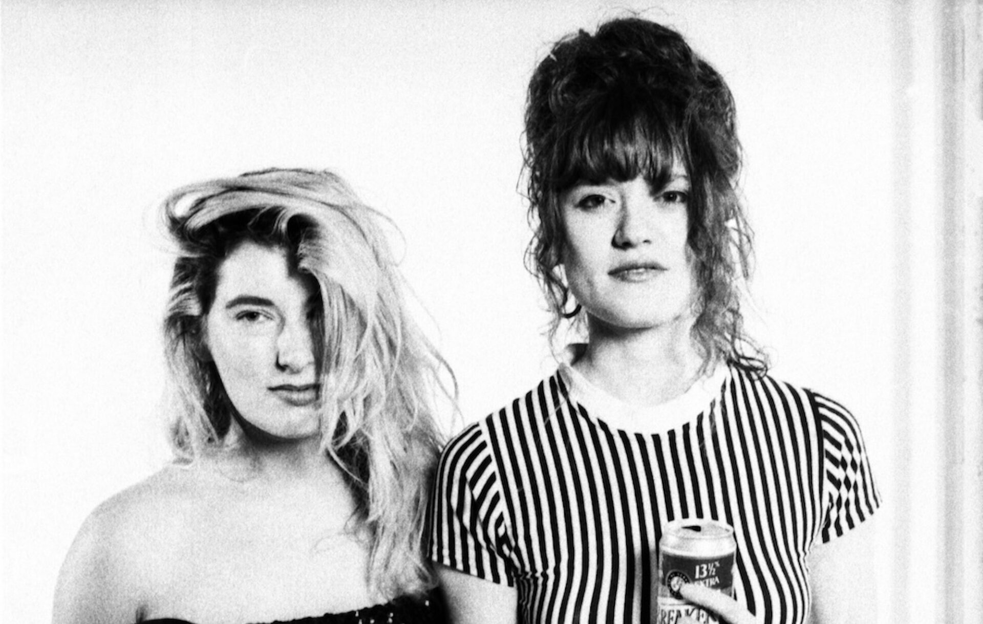 A black-and-white portrait photograph of two ravers