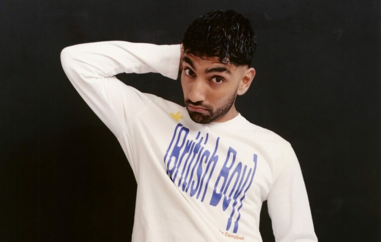 Mawaan Rizwan posing for a photoshoot in a t-shirt saying British Boy