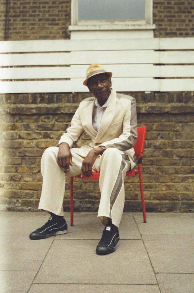 A lifestyle image of a model wearing The Ahluwalia Puma Suede collaboration trainers