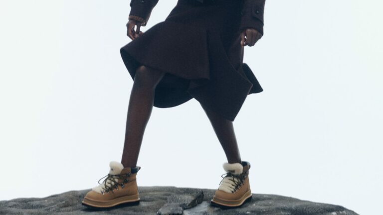 A lifestyle shot of a model wearing the Ugg x Sacai Hiker Boots